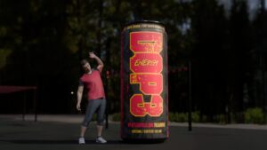 3D-mallinnettu DOP3-energiajuomatölkki suurennettuna ilmatäytteiseksi versiona urheilupuistossa, tölkin vieressä venyttelevä hahmo.